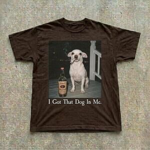 This Is A Brown T Shirt . Below The Is The Text I Got That Dog In Mea?